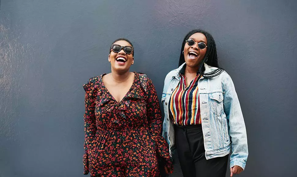 Women laughing together to symbolize boosting mental health or to boost mental health