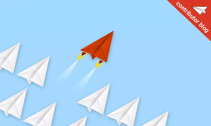 Red paper airplane soaring away from a group of other paper airplanes