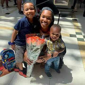 Shetia Burnett poses at commencement with her two sons