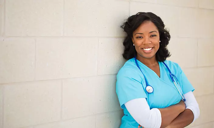 Nurse smiling with her arms crossed
