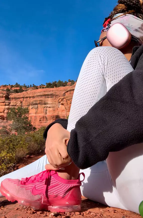 Freda hiking with pink headphones and shoes