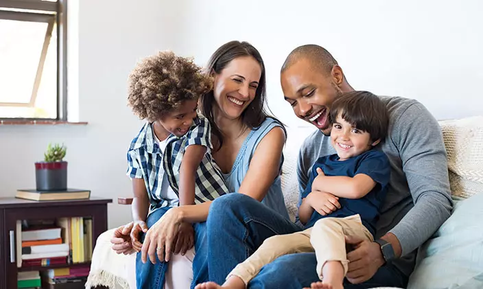 Diverse family enjoying time together on sofa