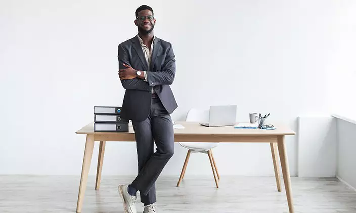 A job seeker leaning on a desk