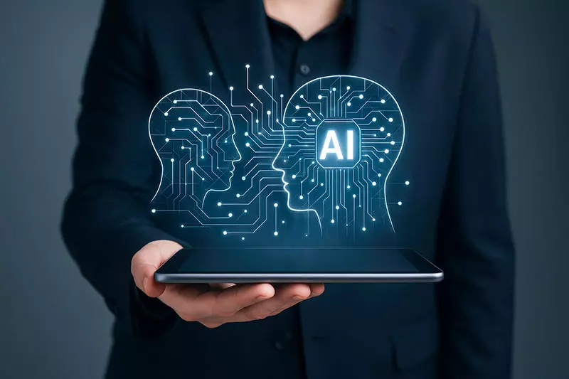 A researcher holds a closed laptop with an illustration of a person's head and AI shown above the laptop