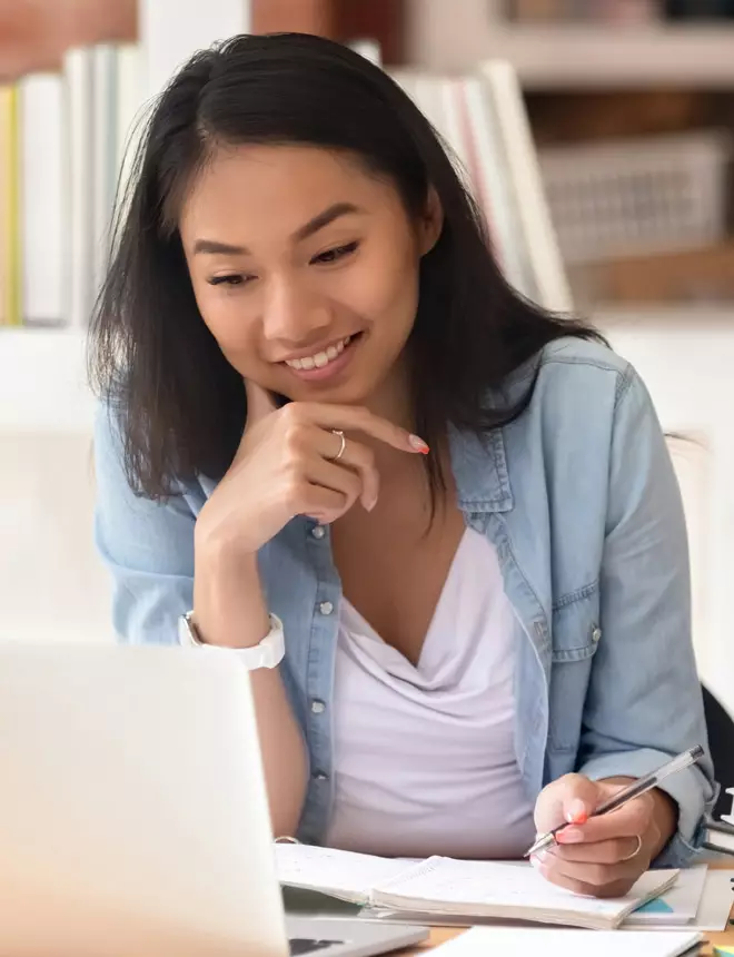 Young professional woman smiling and studying