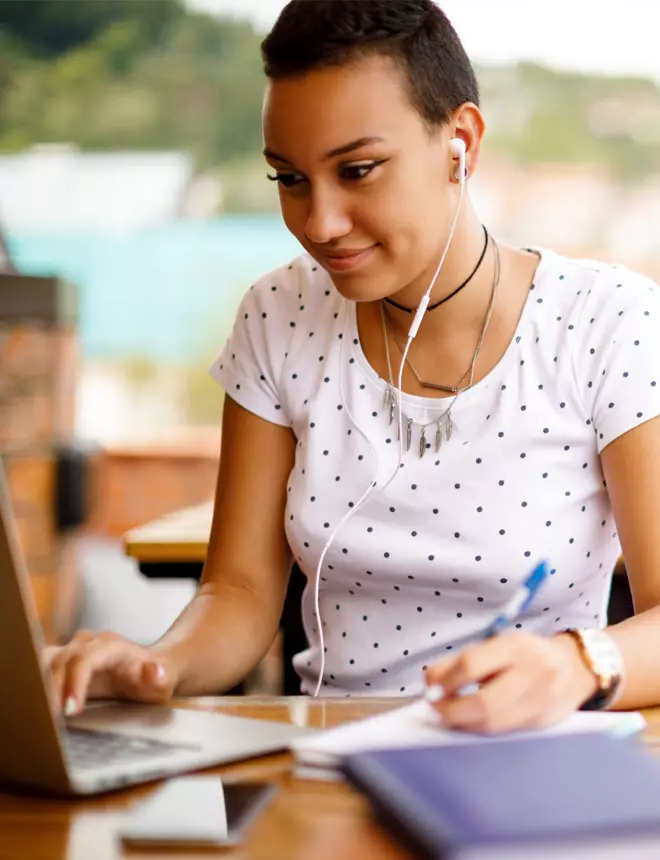 Smiling business professional takes notes on her tablet