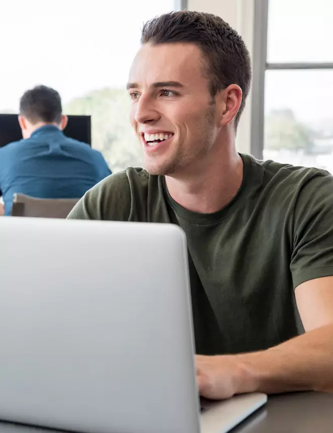 Online student works on an assignment on his laptop