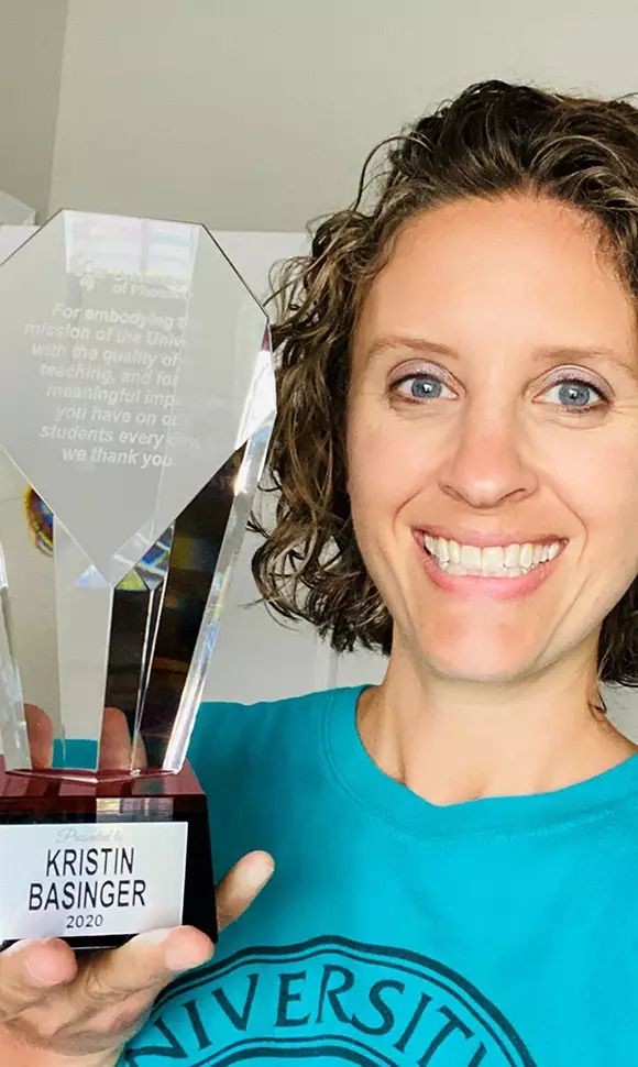 Photo of Kristin Basinger holding an award