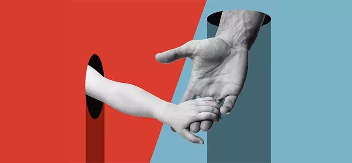 The hand of an older person holding a childs to signify 'family advocate'