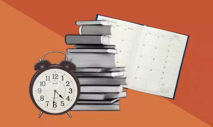 A stack of book, calendar and clock
