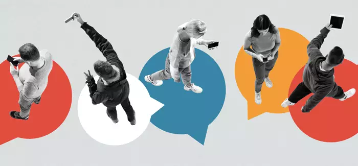 A birdseye view of five people looking at phones and tablets to signify social media marketing