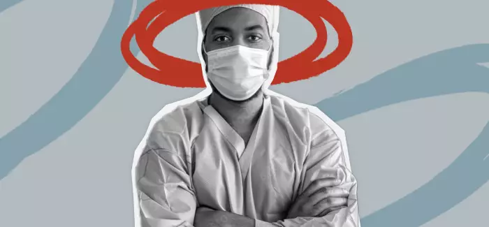 Image of a charge nurse with a mask on and arms crossed