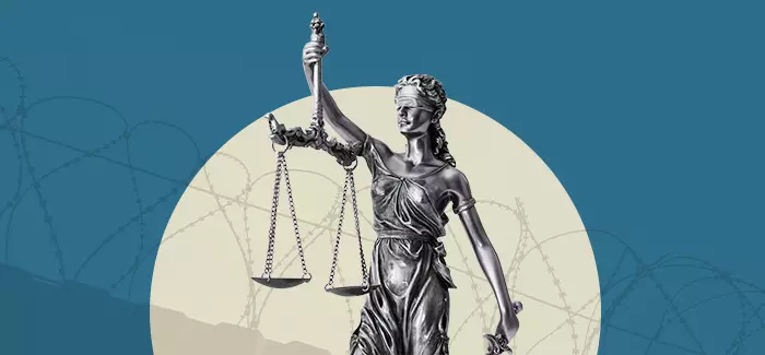 A statue to represent justice and a detention officer