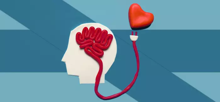 A profile of a human head, with red yarn signifying a brain connecting to a heart to symbolize mental health counseling