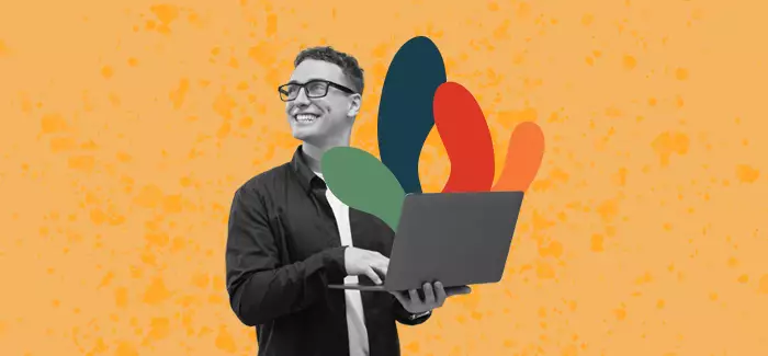 A male student in glasses and holding a laptop to signify a non-traditional student