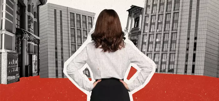 A woman stands facing a city landscape and plans her way to build a business.
