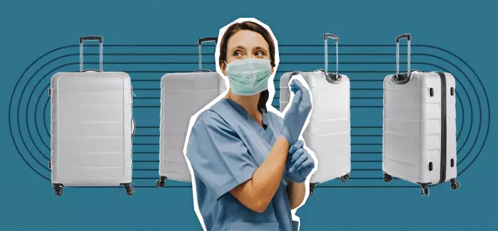 Masked travel nurse standing in front of suitcases