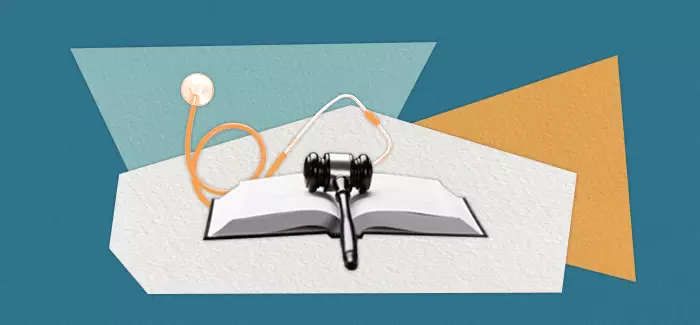 Open text book, gavel, and stethoscope to signify healthcare compliance