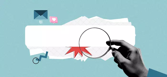 A hand holding a magnify glass up to a search bar