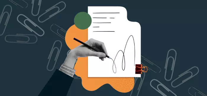 Hand scribbling with a pen surrounded by paper clips to signify a business administration degree