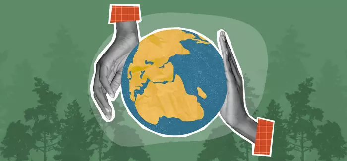 Hands shaped around an image of the globe with the silhouette of trees in the background to signify environmental science