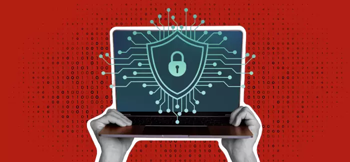 Two hands holding up a laptop with a lock, shield and code on the screen.