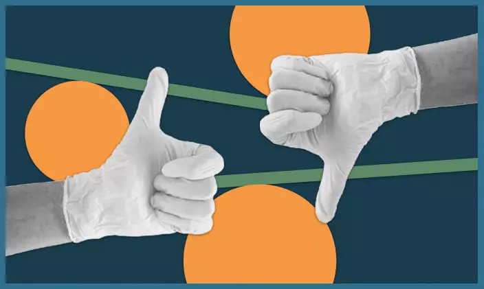 Gloved nurses hands giving a thumbs up and thumbs down to indicate ethics