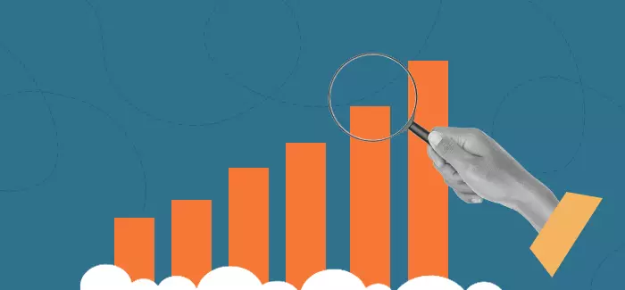 Illustration of magnifying glass over a bar graph to denote the work of a market research analyst