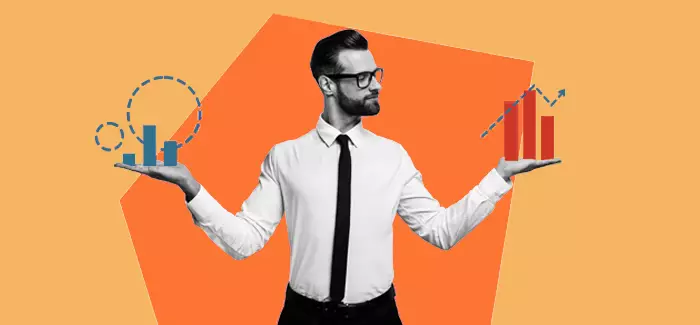 A business professional holding a blue graph in one hand and an orange one in the other to signify the difference between data science vs. data analytics