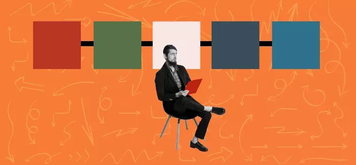 A man sitting in front of a line of different color square to signify the timeline of a project using Kanban vs. Scrum