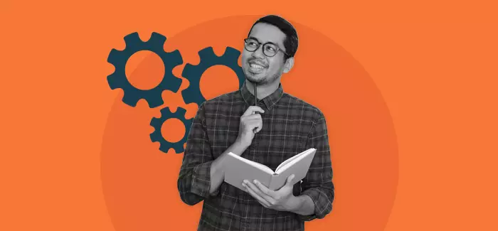 A male student in a thinking pose with a book open to represent motivation and students in higher education