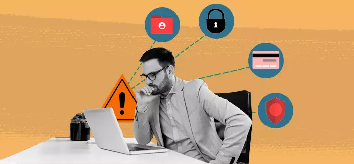 A male information security analyst working on a computer with security-related icons including a file folder, padlock, credit card, and shield