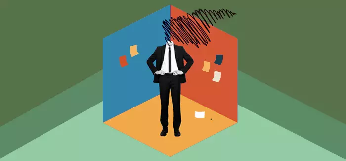 An industrial-organizational psychologist with scribbles for a head standing in a cubicle with post-it notes on the walls