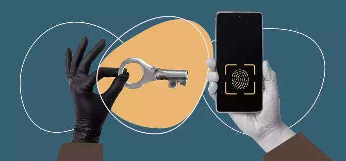Someone holding a key toward a phone open to a fingerprint scan to signify a bachelor’s in cybersecurity