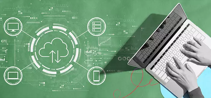 A student working on earning a cloud computing certificate typing on a laptop with cloud computing icons in the background