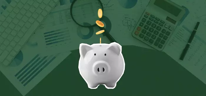 Coins dropped into a white piggy bank with a green background to signify creating a budget