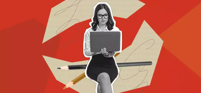 Woman with her laptop working on a creative writing project, sitting on pencils with scribbled paper behind her