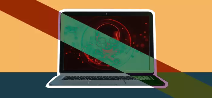 Alaptop with a shadowy image of a skull and crossbones on the screen