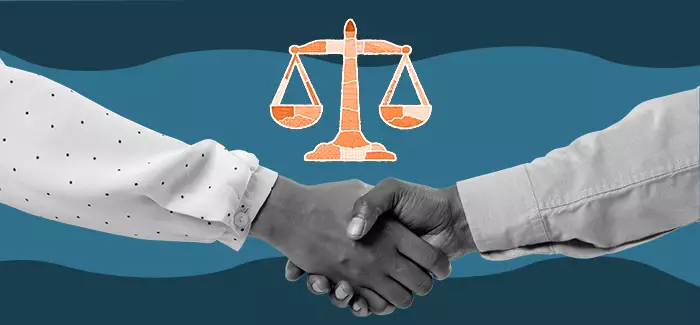 Two hands shaking underneath the scales of justice to signify criminal justice organizations for students