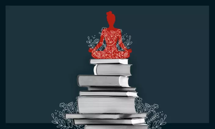 Silhouette of a woman in a lotus yoga pose perched upon a stack of books