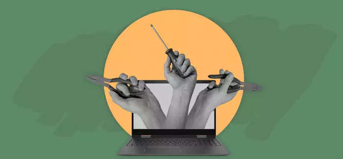 Hand reaching out of a laptop holding tools to signify human centric roles
