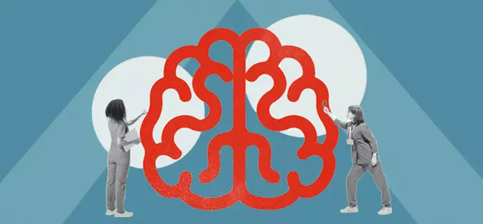 Two nurse educators looking at an oversize cartoon of a brain