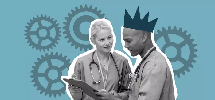 Two nurses overviewing a clipboard, one wears a crown to signify director of nursing