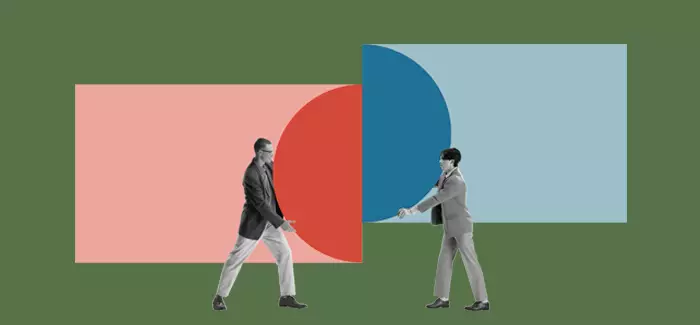 Two logistics managers, each holding half of a circle, one red and one blue, and pushing them together.