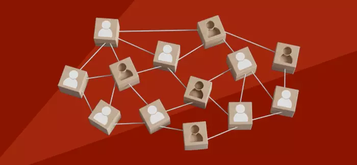 An illustration of interconnected wooden blocks with people on them, and several lacking the individuals to represent labor shortage