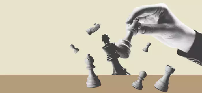 A hand knocking over chess pieces to signify the ROI of strategic workforce development