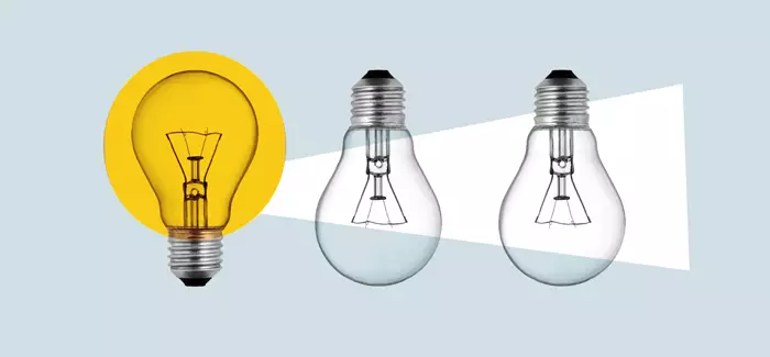 A lighted lightbulb shining on two unlit lightbulbs to represent upskilling employees