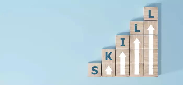Building blocks spell out "skill" to signify skill building