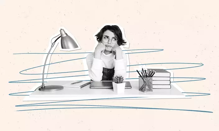 A woman sitting at her desk thinking about how to say no to her boss