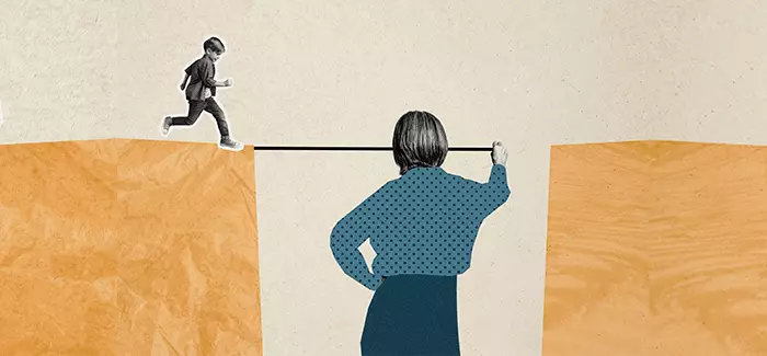Woman making a bridge for a child to walk across to signify the support skills of a social worker